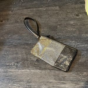 this is a little purse that is gold,sliver, and a dark grey